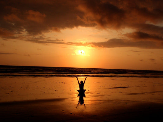 someone meditating in the sunset